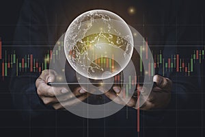 A man with tablet and a hand holding a globe graphic and stock chart Investment concepts, business concepts, technology concepts