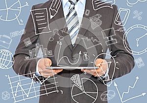 Man with tablet in hands and business sketches