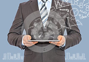 Man with tablet in hands and business sketches