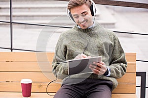 Man with tablet and headphones