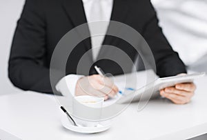 Man with tablet pc and cup of coffee