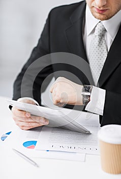 Man with tablet pc and cup of coffee