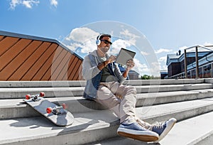 Man with tablet pc and headphones on roof top