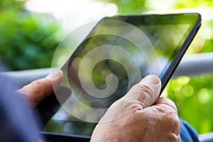 man with tablet pc in park