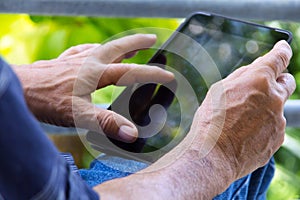 man with tablet pc in park