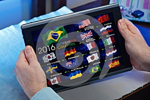 man on tablet watching a channel of Olympics sports on TV online