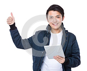 Man with tableta and thumb up photo