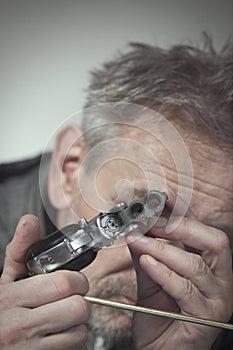 Checking, cleaning and loading of small derringer .38 special handgun by man