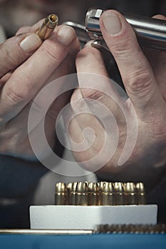 Checking, cleaning and loading of small derringer .38 special handgun by man