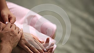 Man take lady`s hand with engagement ring. Background of lake