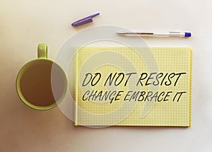 Man take a paper with text Do Not Resist Change Embrace It on the shirt with office background