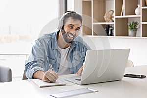 Man take part in online class using laptop and application