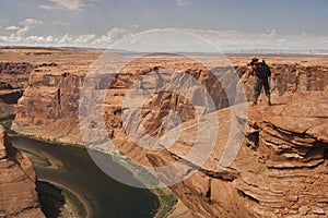 Man take pictures of Horseshoe Bend in Arizona