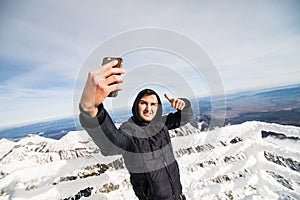 Man take selfie in Winter in High Tatras Mountains. High Tatry. Slovakia