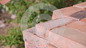 Man takes brick for construction from brick warehouse stack