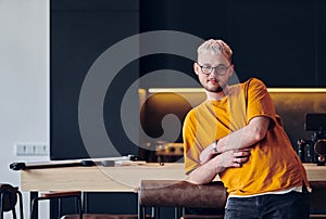 A man takes a brief rest from work in a modern startup coworking center, using the moment to recharge and relax with