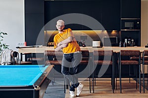 A man takes a brief rest from work in a modern startup coworking center, using the moment to recharge and relax with