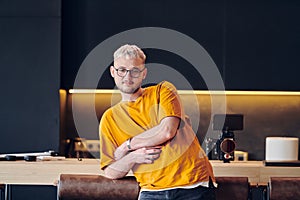 A man takes a brief rest from work in a modern startup coworking center, using the moment to recharge and relax with