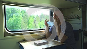 Man takes off his medical mask on the train