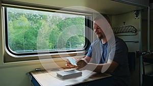 Man takes off his medical mask on the train