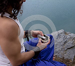Man takes out the harmonica from the case.