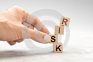 The man takes the RISK cube with his hand. Unjustified risk