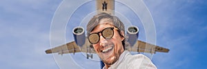 A man takes a selfie against the sky and a flying plane BANNER, LONG FORMAT