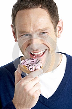 Man Taking Bite Of Doughnut