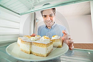 Man Taking Cake View From Inside The Refrigerator