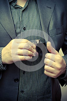 Man taking a flask out of his suit pocket