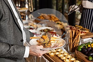 Man taking food from breakfast table