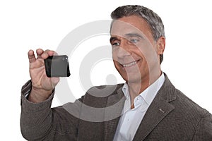 Man taking with his cameraphone