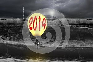 Man taking lamp balloon with dramatic ocean, lightning and light