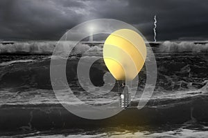 Man taking lamp balloon with dramatic ocean, lightning and light