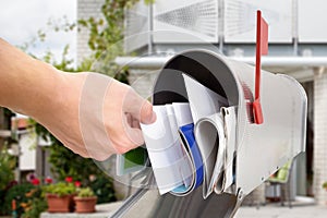 Man taking letter from mailbox