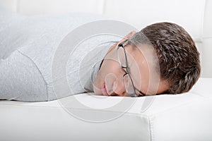 Man taking little nap on sofa
