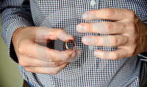 Man taking off his wedding ring. concept of treason, infidelity, betrayal.