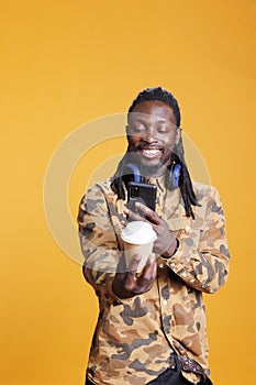 Man taking photo of cup with coffee