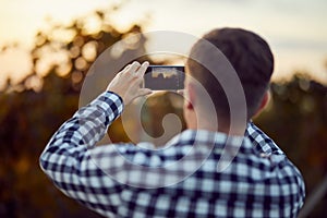 Man taking photo with digital camera on mobile phone