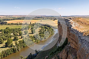 Man taking a photo on the edge of a cliff next to the Pisuerga river in Valladolid photo