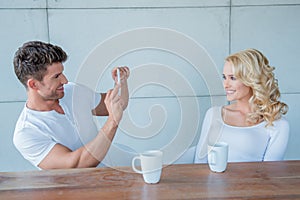 Man taking a photo of his beautiful blond wife