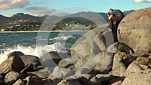 Man taking a photos with dslr camera outdoors, on the beach