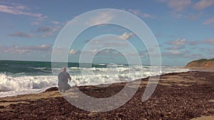 Man taking a photos with dslr camera outdoors, on the beach