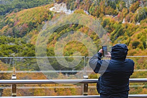 Man taking photos at mirador garibaldi, tierra del fuego, argentina photo