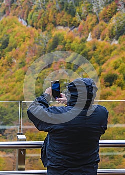 Man taking photos at mirador garibaldi, tierra del fuego, argentina photo