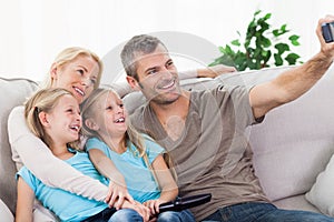 Man taking picture of his children and wife