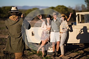 Man taking a picture of his friends during safari vacation