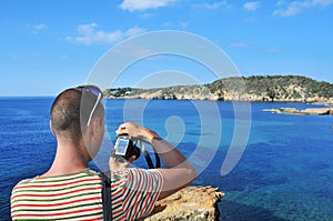 Man taking a picture in Ibiza Island, Spain