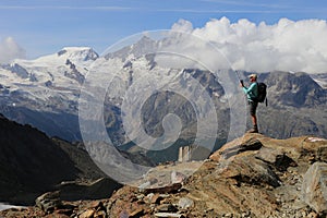 Man taking picture on mountain in Saasvalley, Switzerland