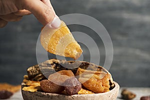 Man taking a piece of dried pear